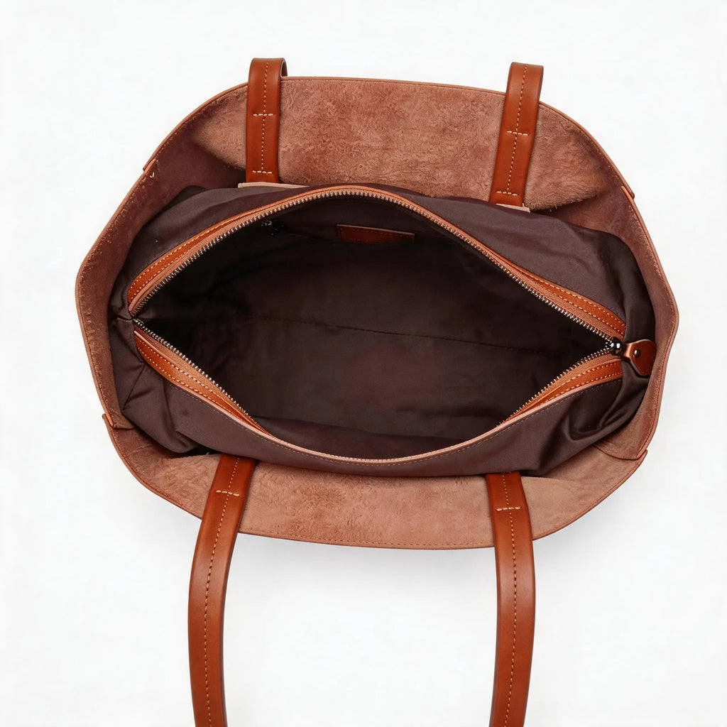 Brown leather backpack with open front compartment on a white background