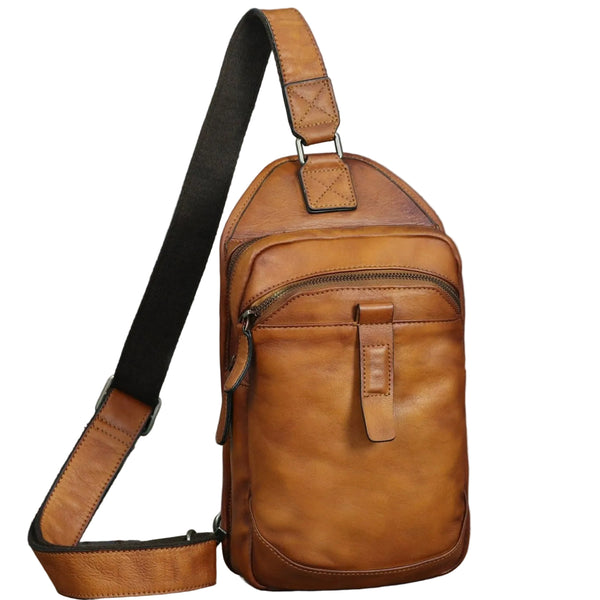 A brown genuine leather sling bag with a crossbody chest strap and backpack design, featuring multiple compartments and a zipper closure.