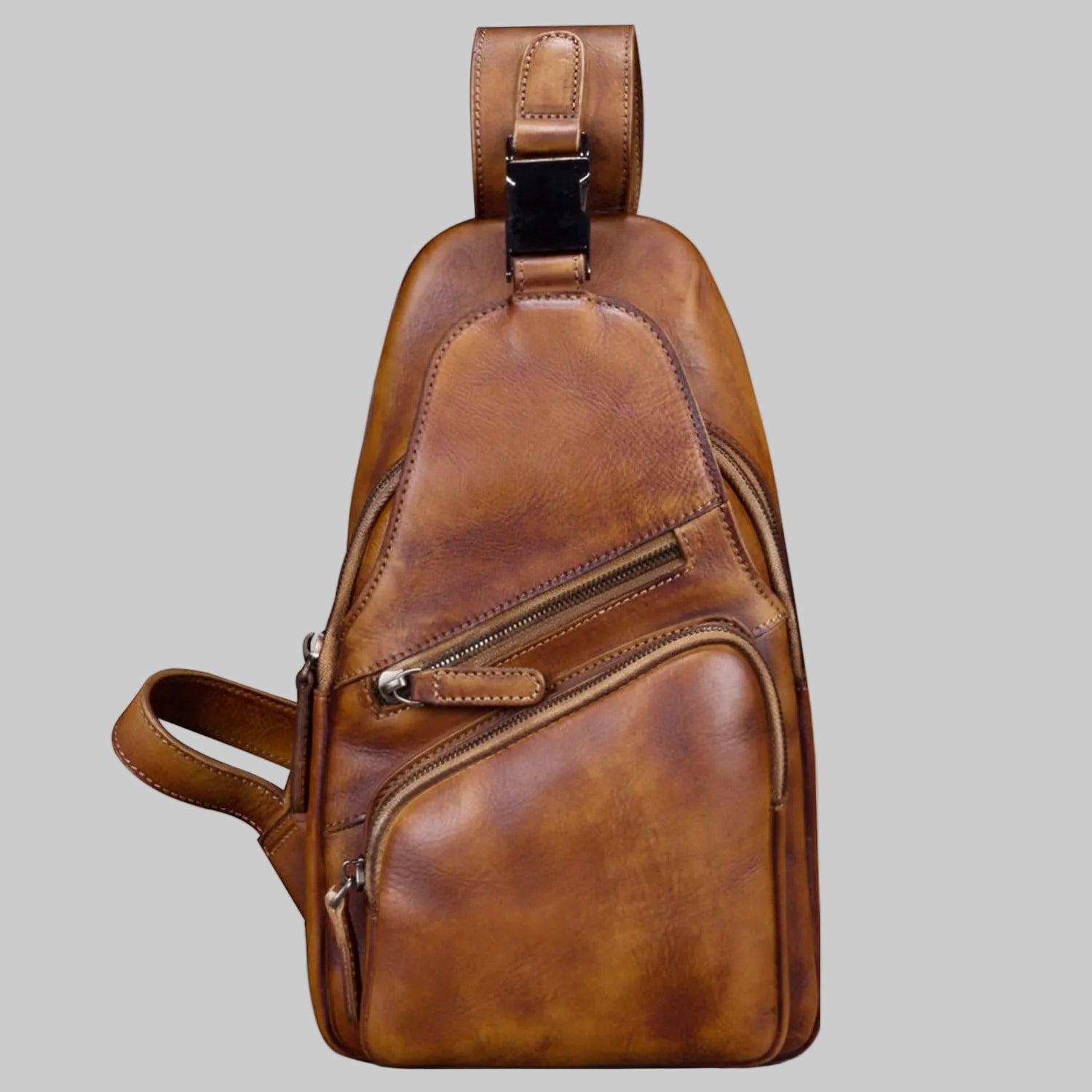 Brown leather sling bag on a white background
