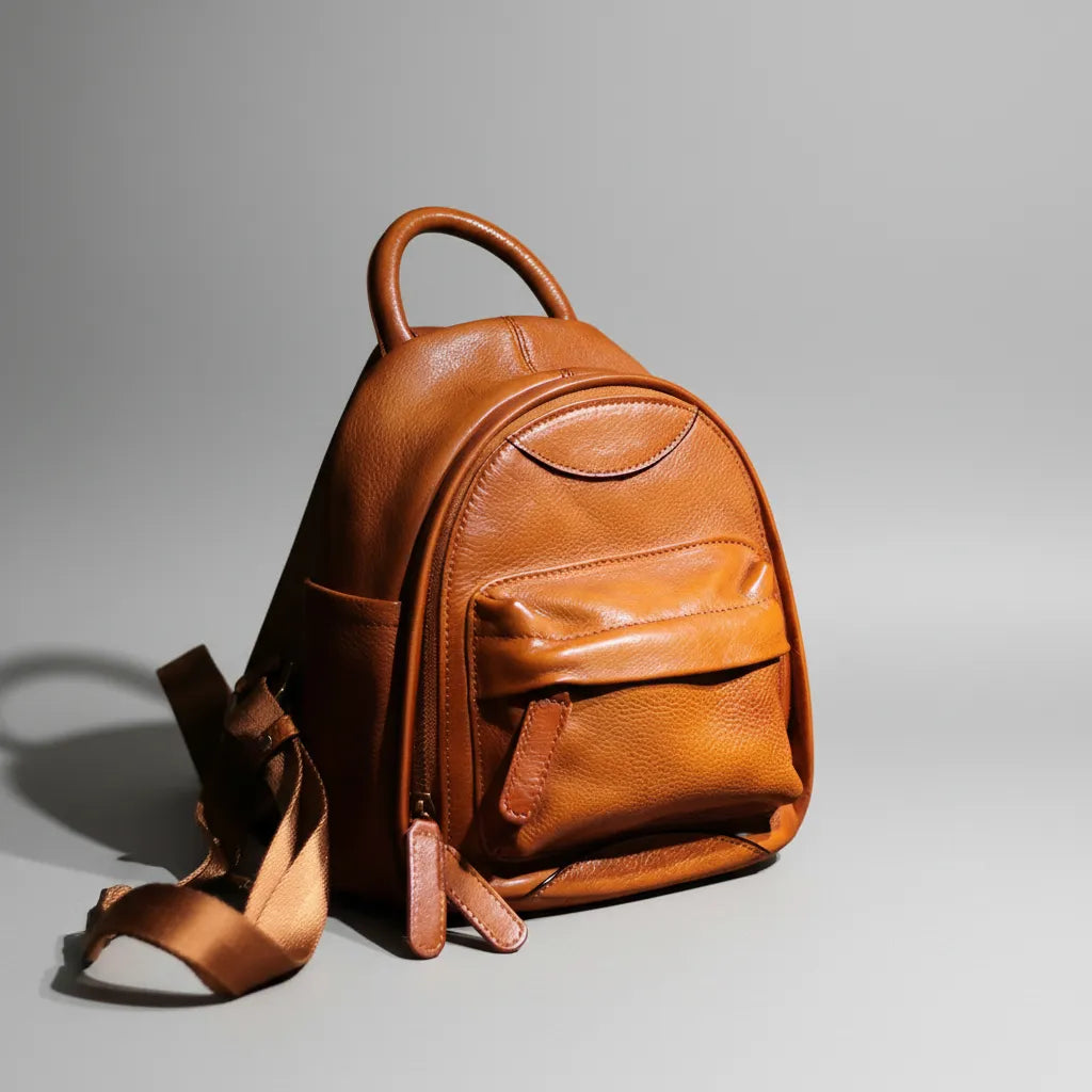 Brown leather backpack on a gray background