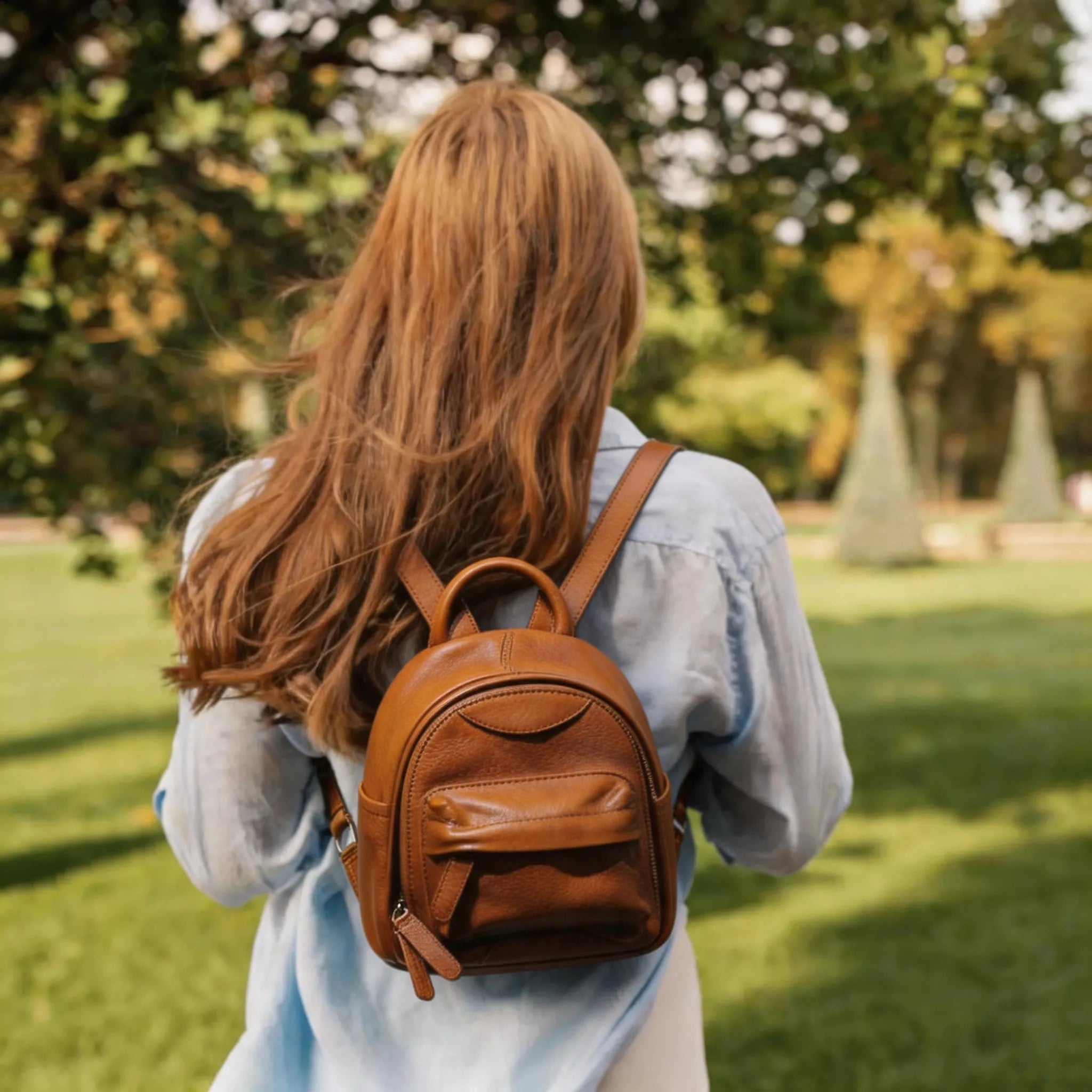 Person with a brown backpack walking in a park