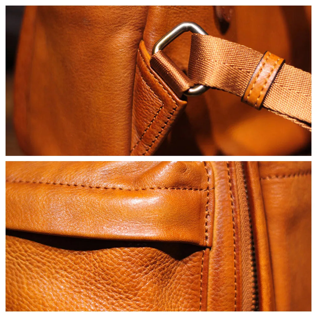 Close-up of a brown leather bag with strap and stitching details.