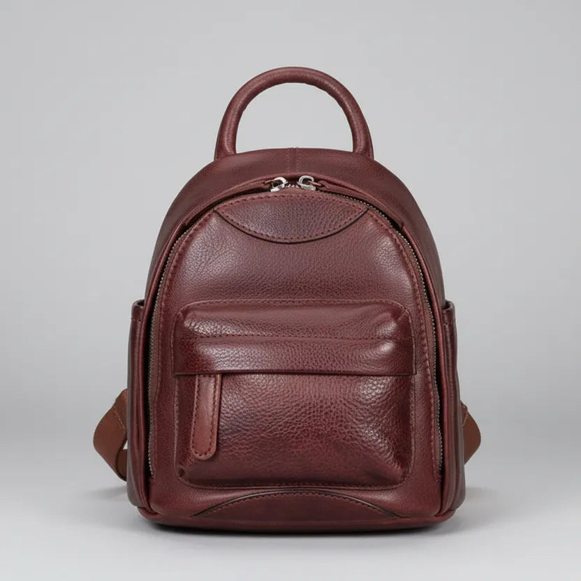 Brown leather backpack on a gray background