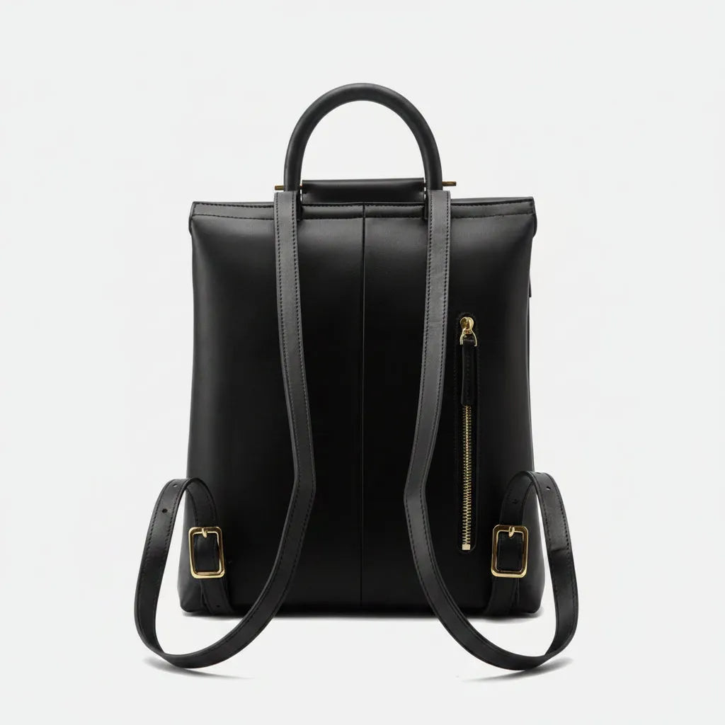 Black backpack with gold zippers on a white background
