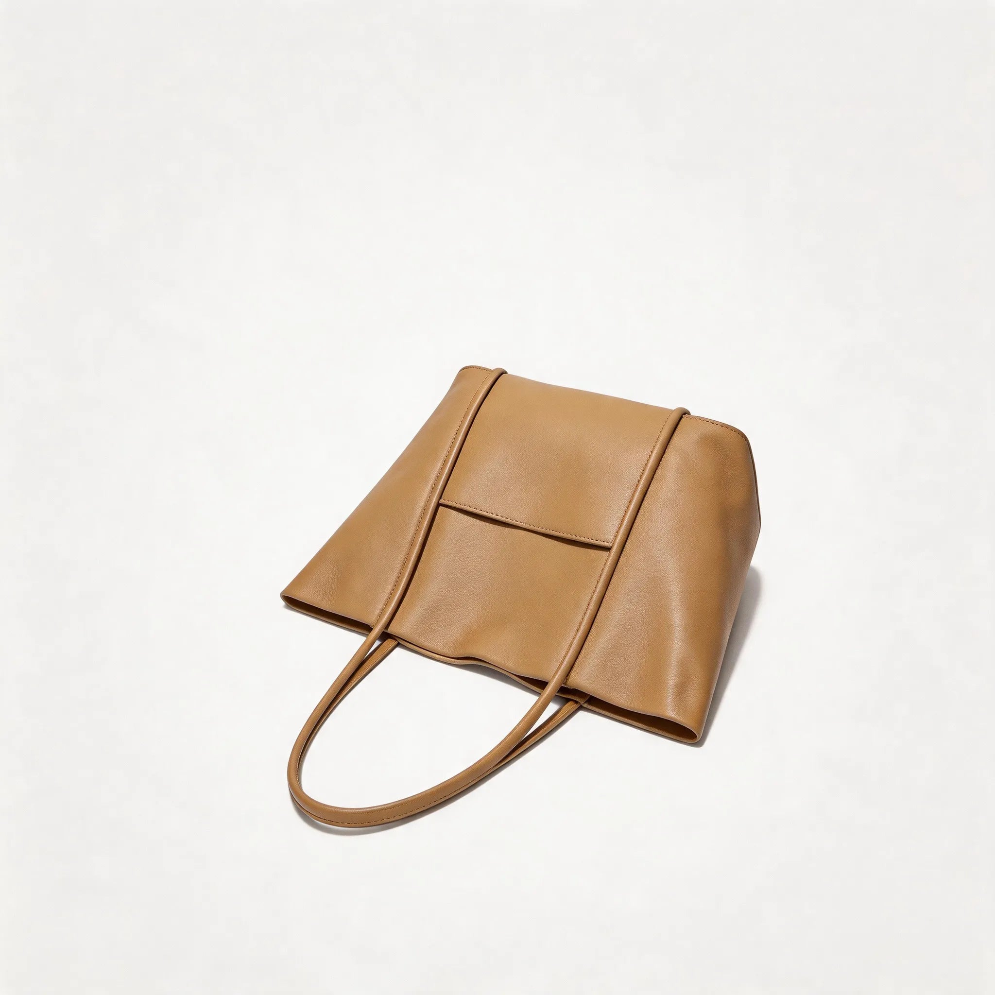 Tan leather handbag on a white background