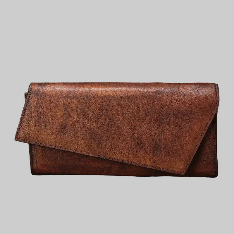 Brown leather wallet on a rustic wooden surface with a blurred natural background