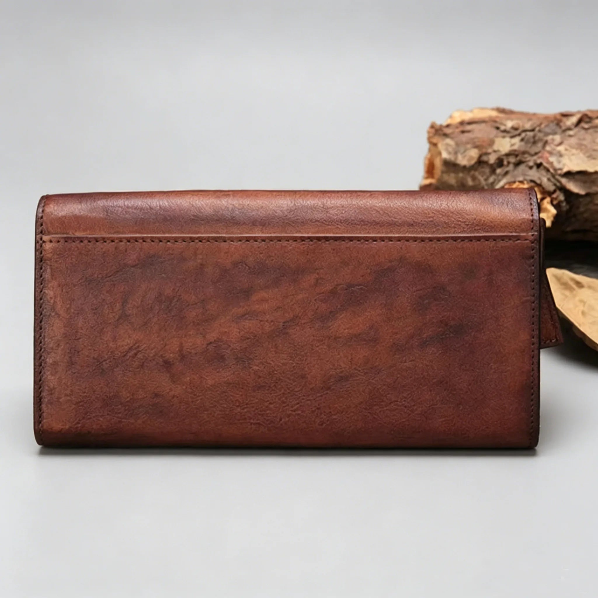 Brown leather wallet on a light gray background