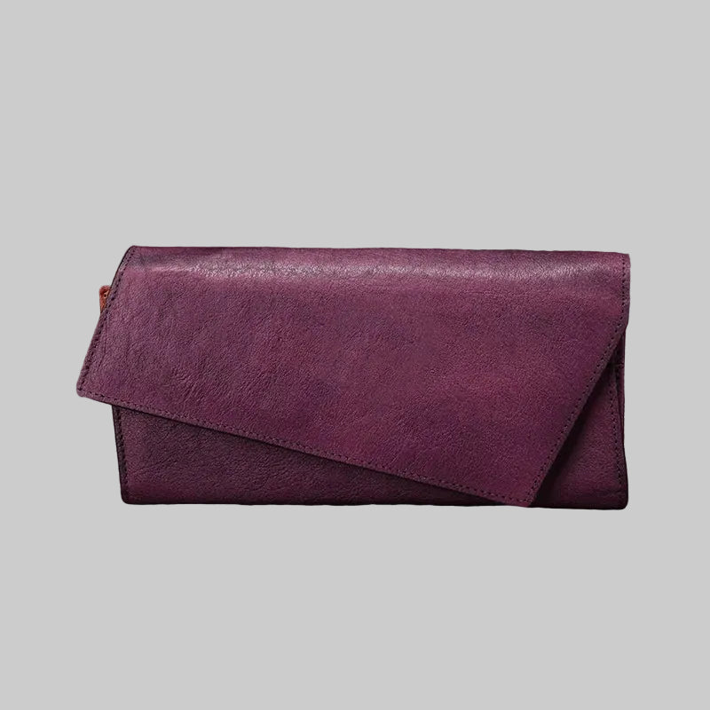 Purple wallet on a rustic wooden surface with natural elements.