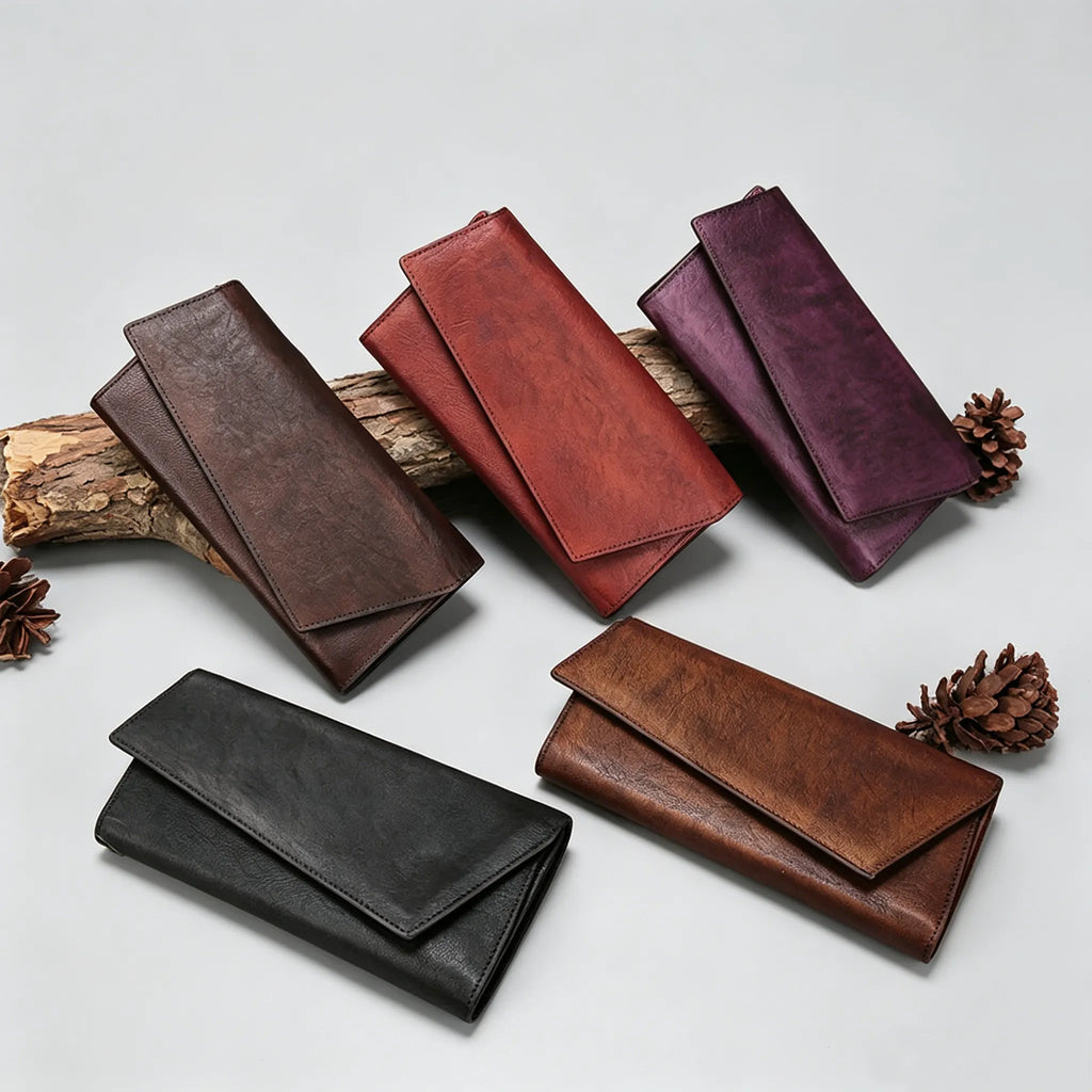 Set of leather wallets in various colors on a light gray background with pine cones.