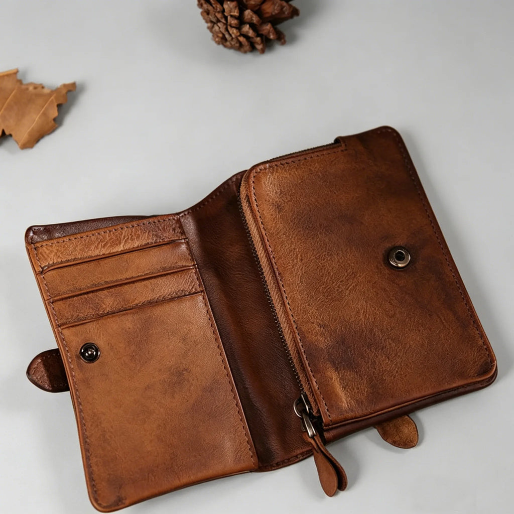 Brown leather wallet on a light gray surface with decorative elements.