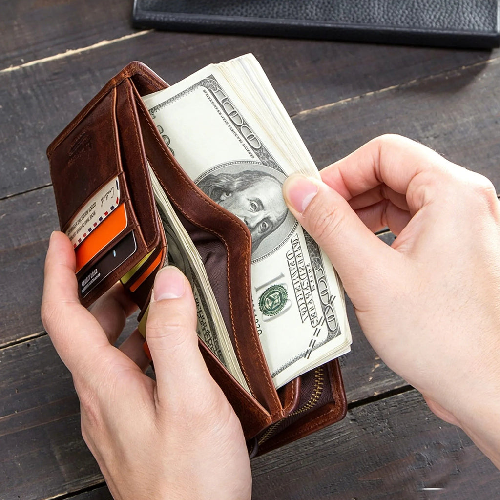Brown leather wallet with money on a wooden surface