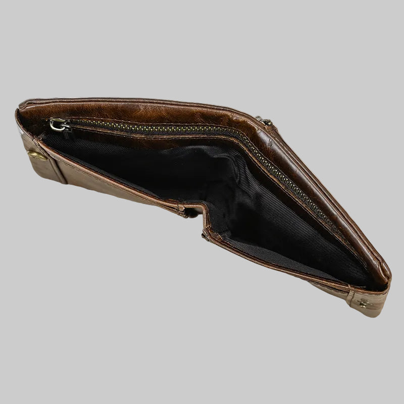 Brown leather clutch bag on a wooden surface