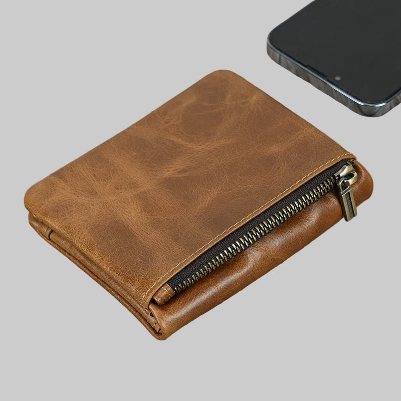 Brown leather wallet with a zipper on a gray background