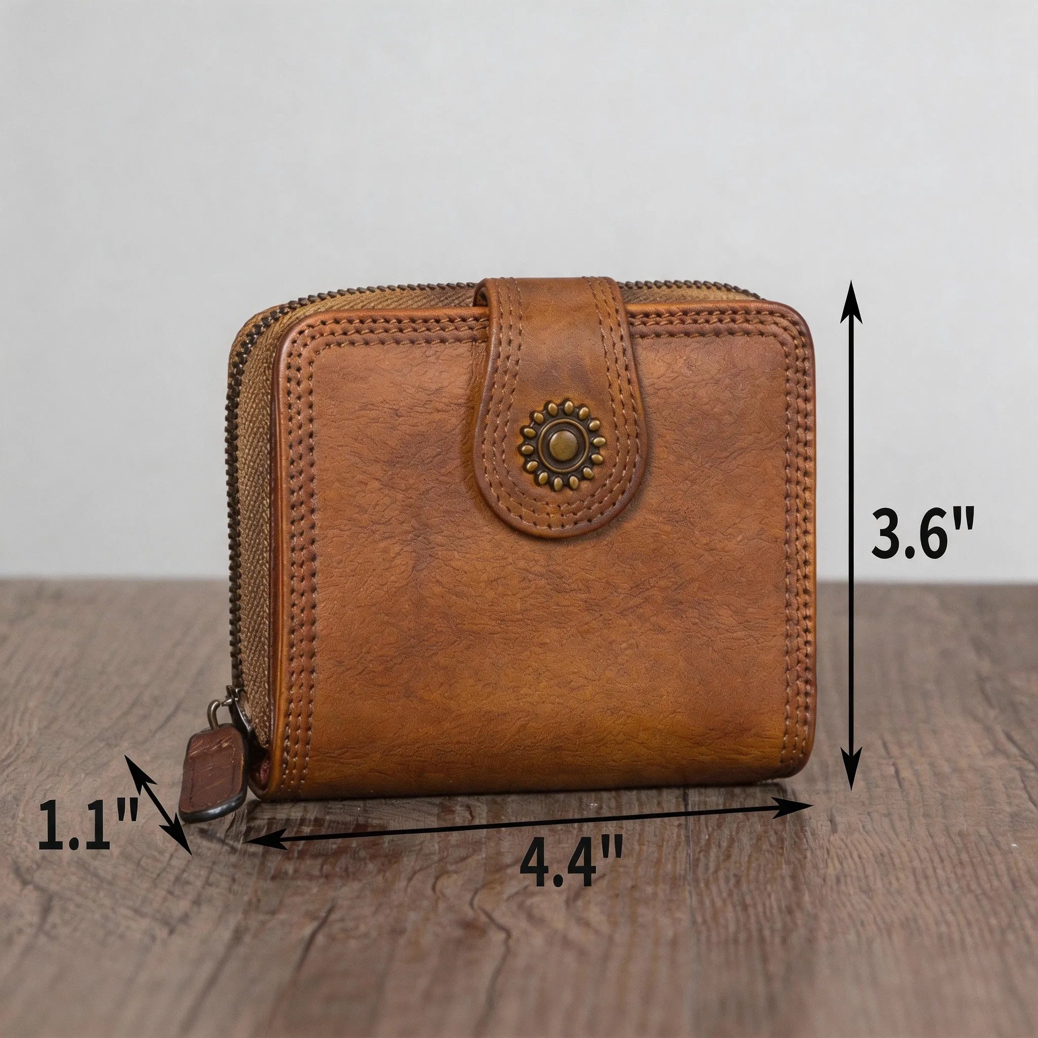 Brown leather wallet with measurements on a wooden surface