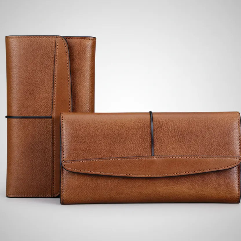 Brown leather wallet and passport holder on a light gray background