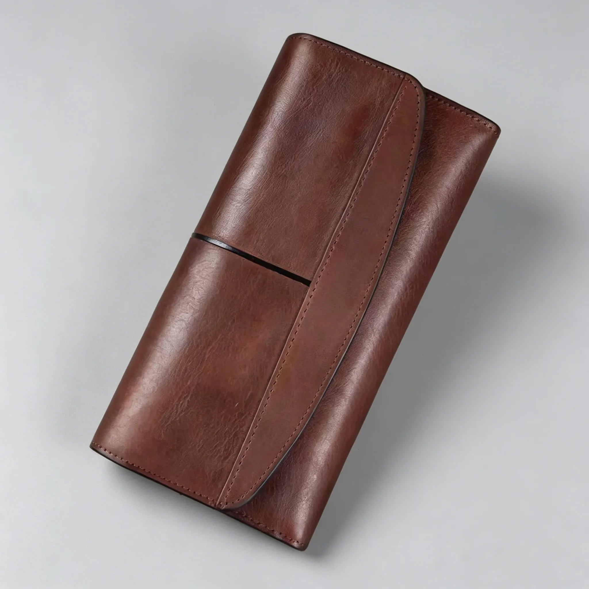 Brown leather wallet on a light gray background