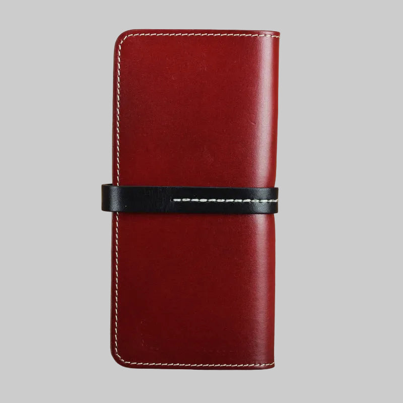 Red leather phone case with black band on a brown background