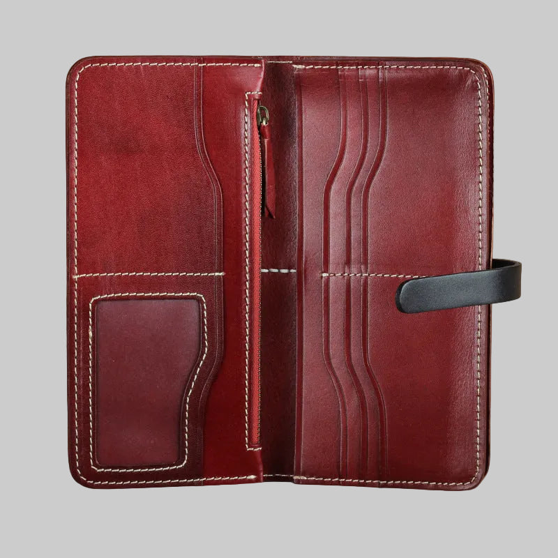 Red leather wallet with stitching details on a beige background
