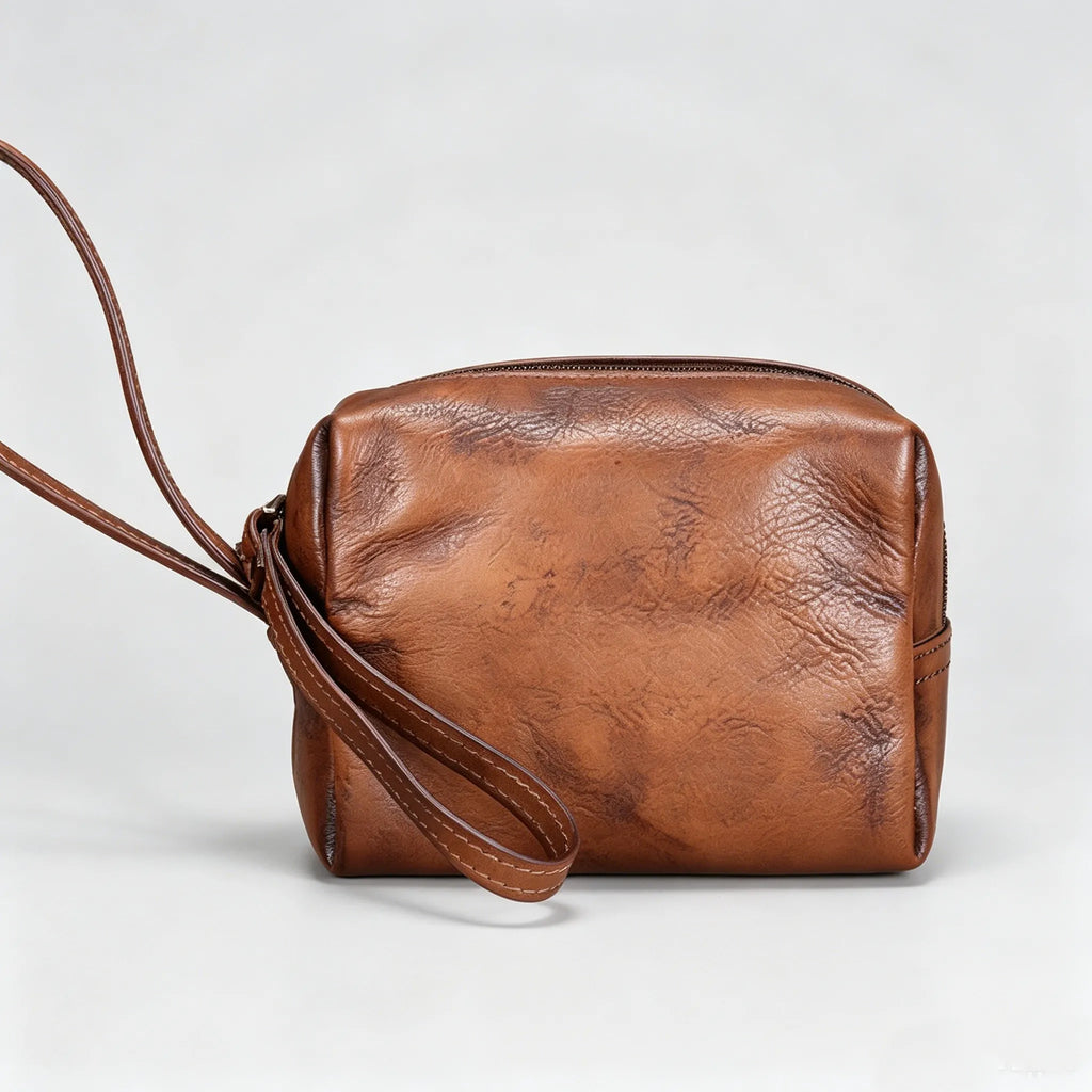 Brown leather crossbody bag on a light gray background