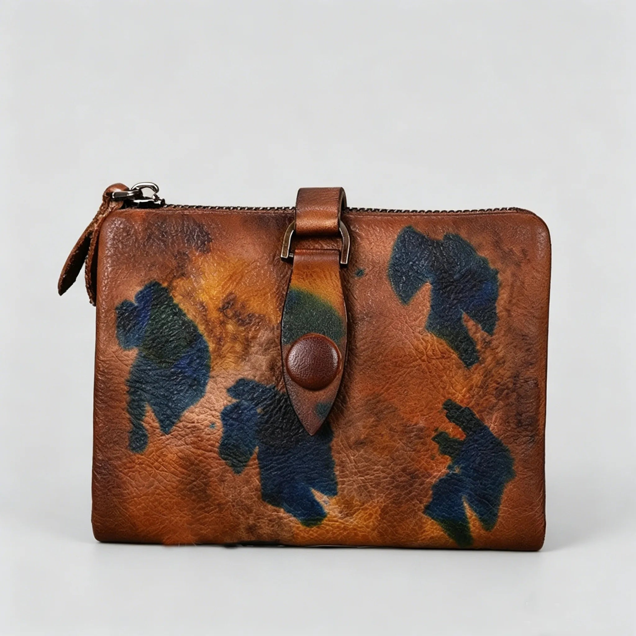Brown leather wallet with blue floral patterns on a light gray background