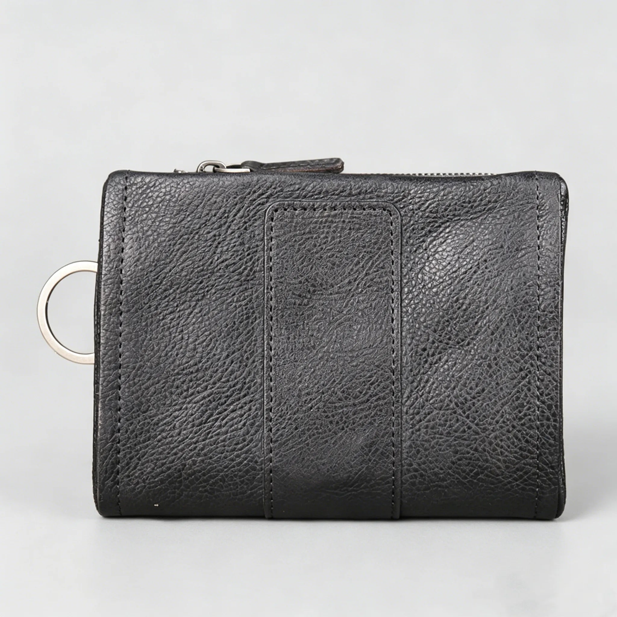 Black leather wallet with a key ring on a light gray background