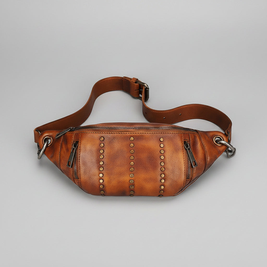 Brown leather waist bag with studs on a gray background