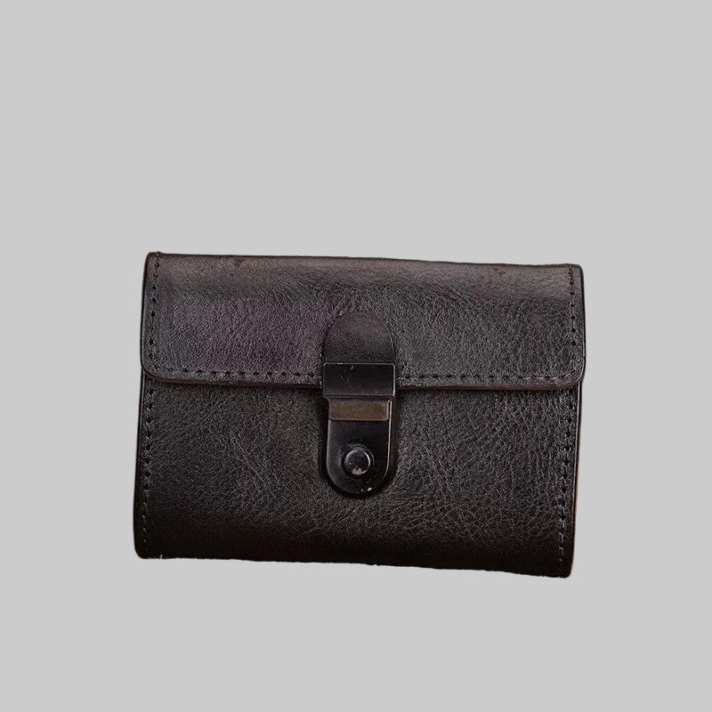 Black leather wallet with a buckle on a textured surface