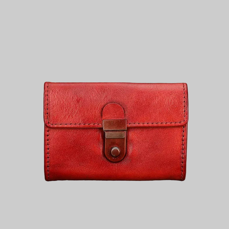 Red leather wallet with a lock on a textured surface