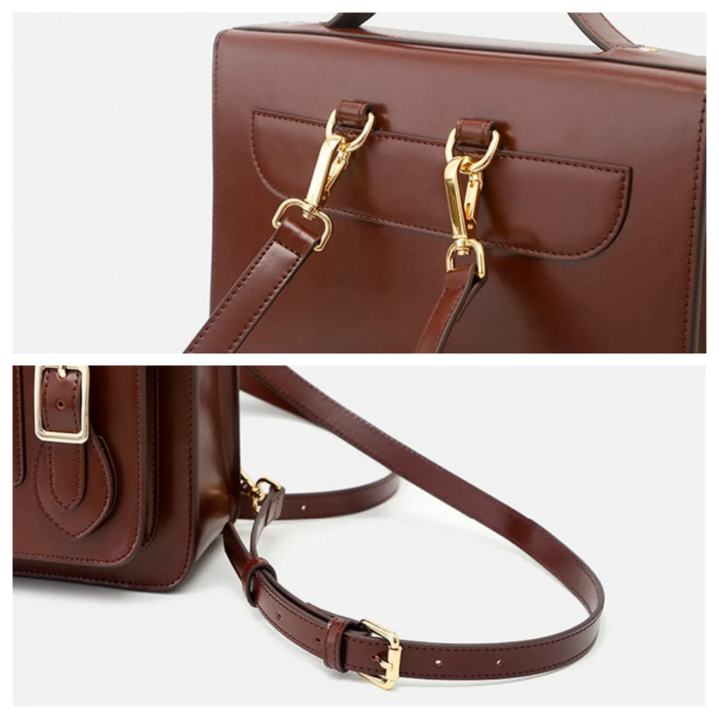 Brown leather handbag with gold hardware on a white background