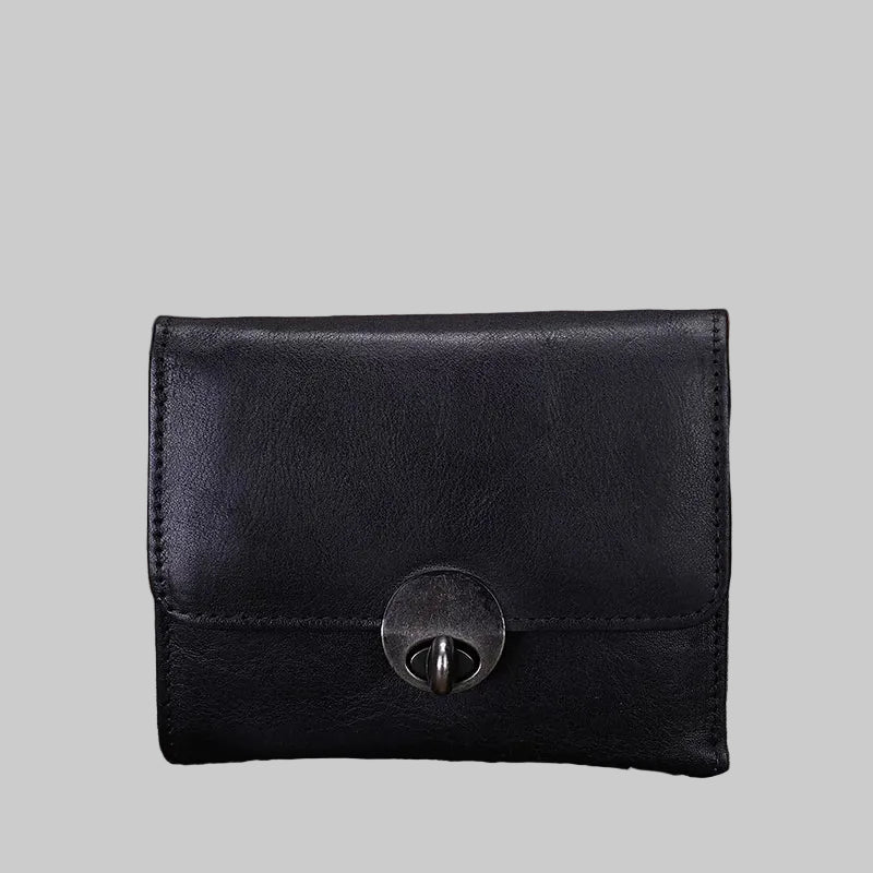 Black leather wallet with a metal clasp on a textured surface