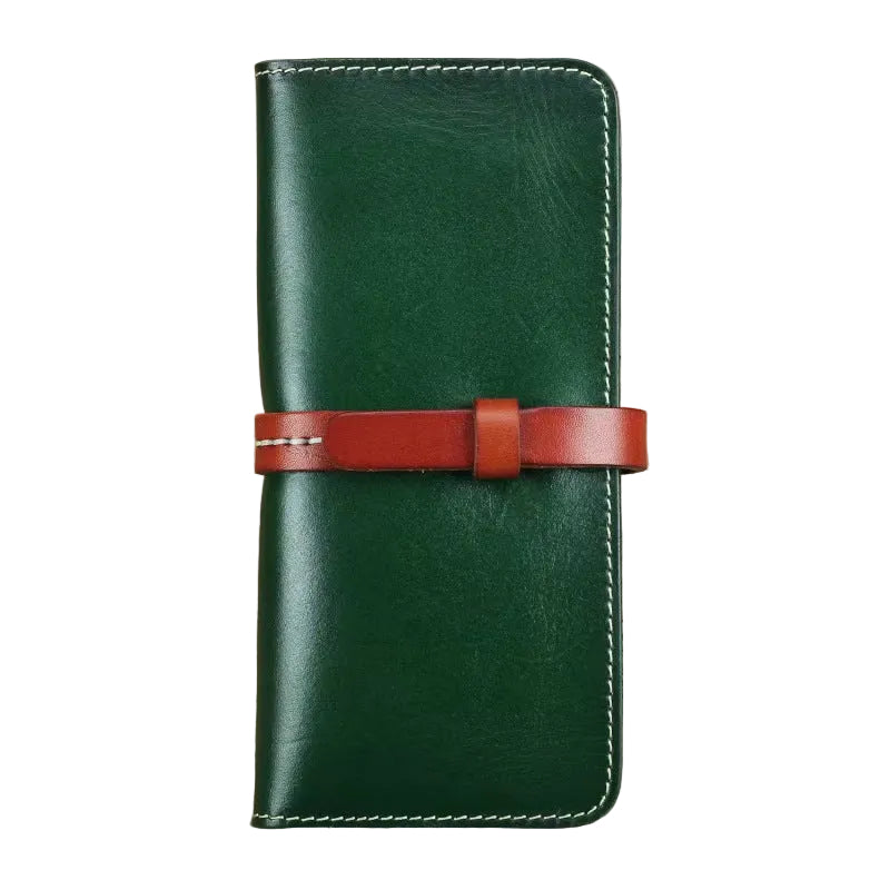 Green full grain leather long wallet with brown leather strap closure, handmade white stitching, front view on white background