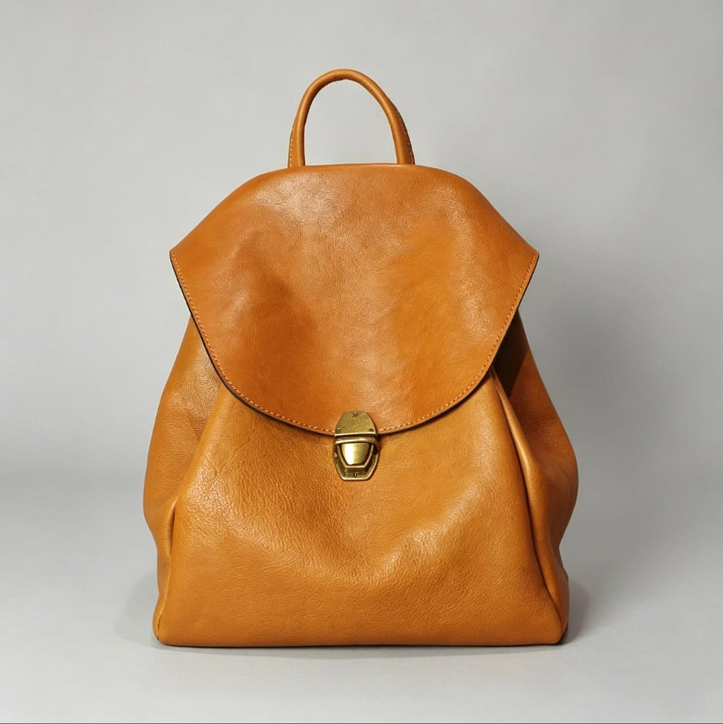 Brown leather backpack on a light gray background