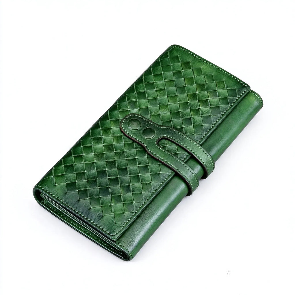 Green woven full grain leather long wallet, angled front view, handmade leather strap closure, on plain white background