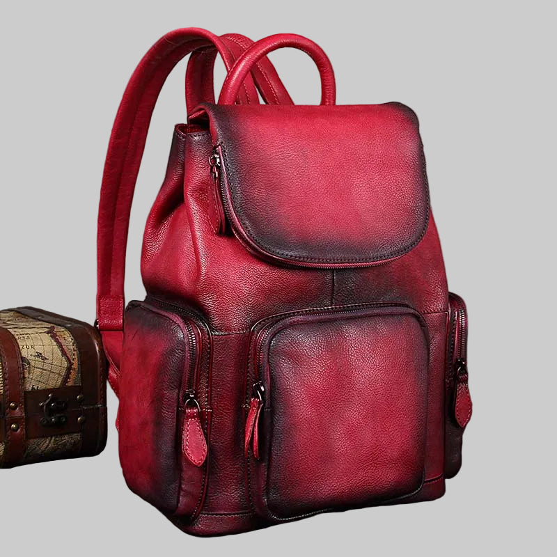 Red leather backpack on a gray background