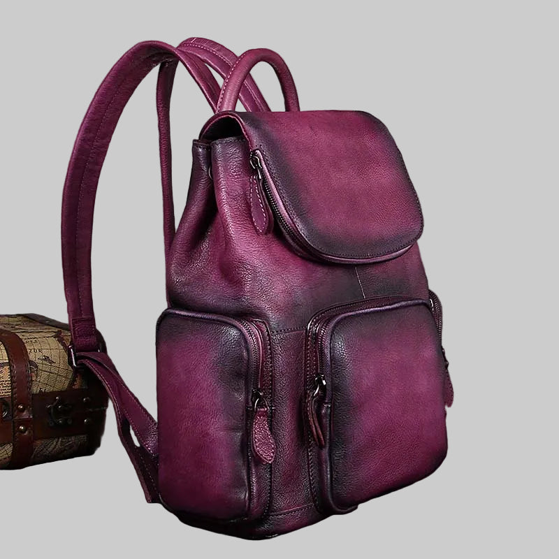 Purple leather backpack on a light gray background