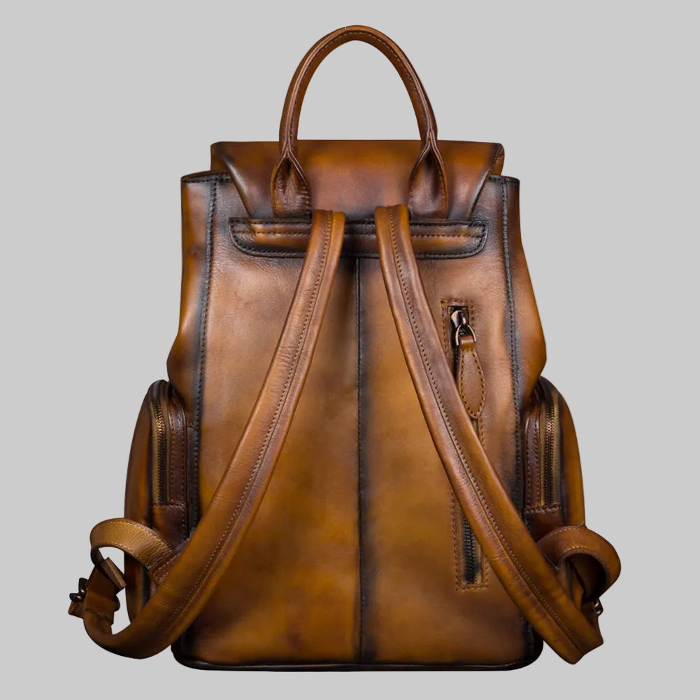 Brown leather backpack on a light gray background