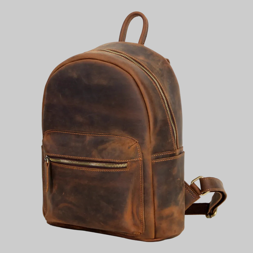 Brown leather backpack on a gray background