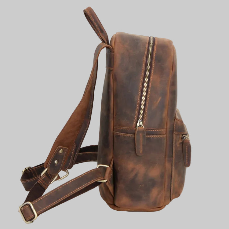 Brown leather backpack on a gray background