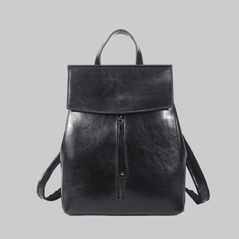 Black leather backpack on a white background