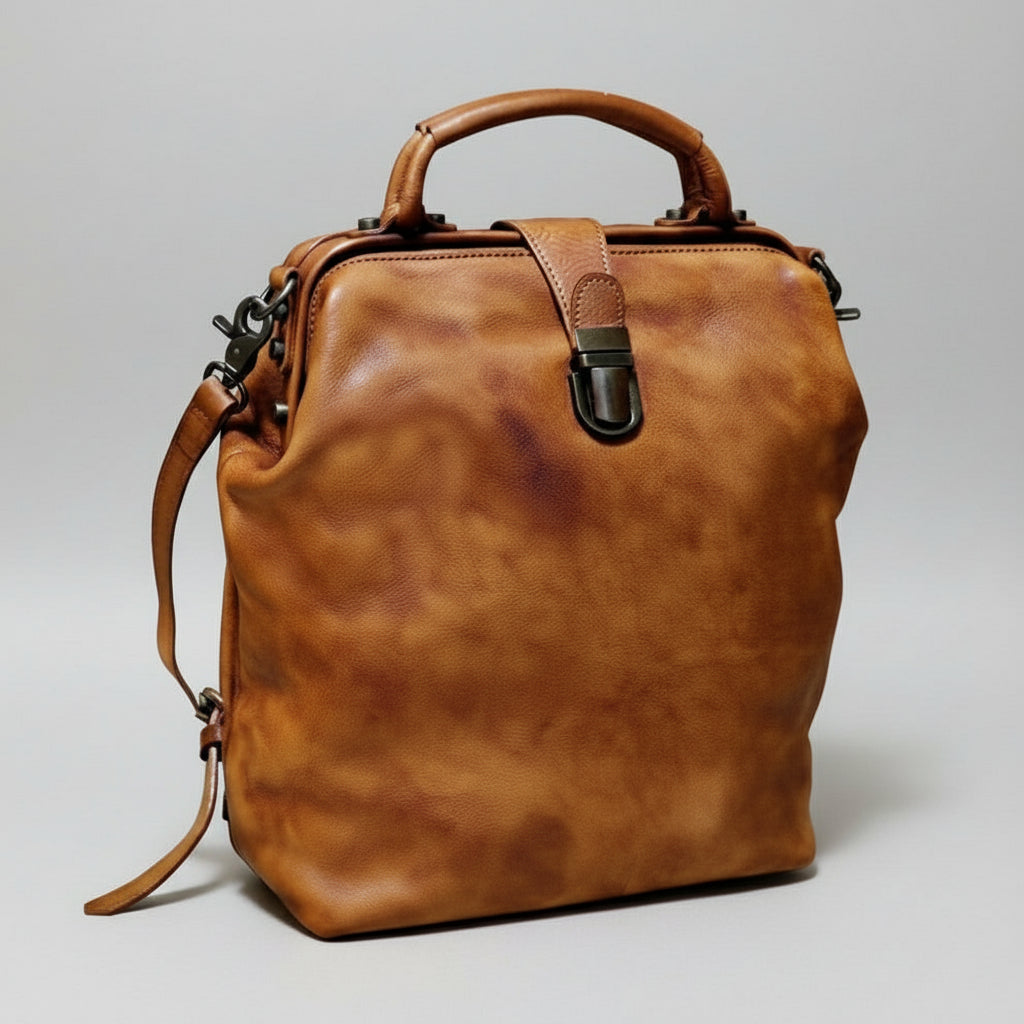 Brown leather bag on a light gray background