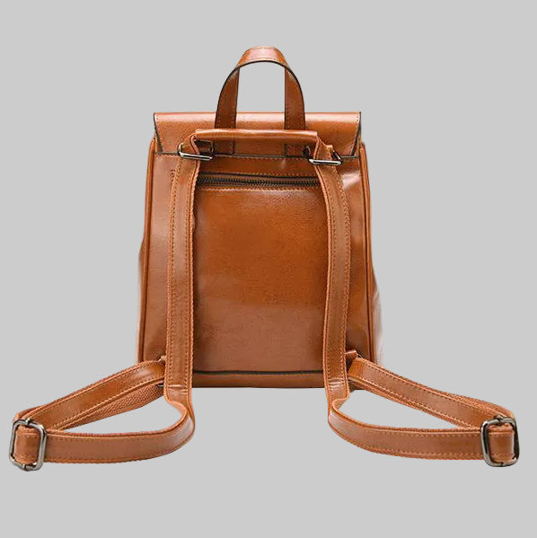 Brown leather backpack on a gray background