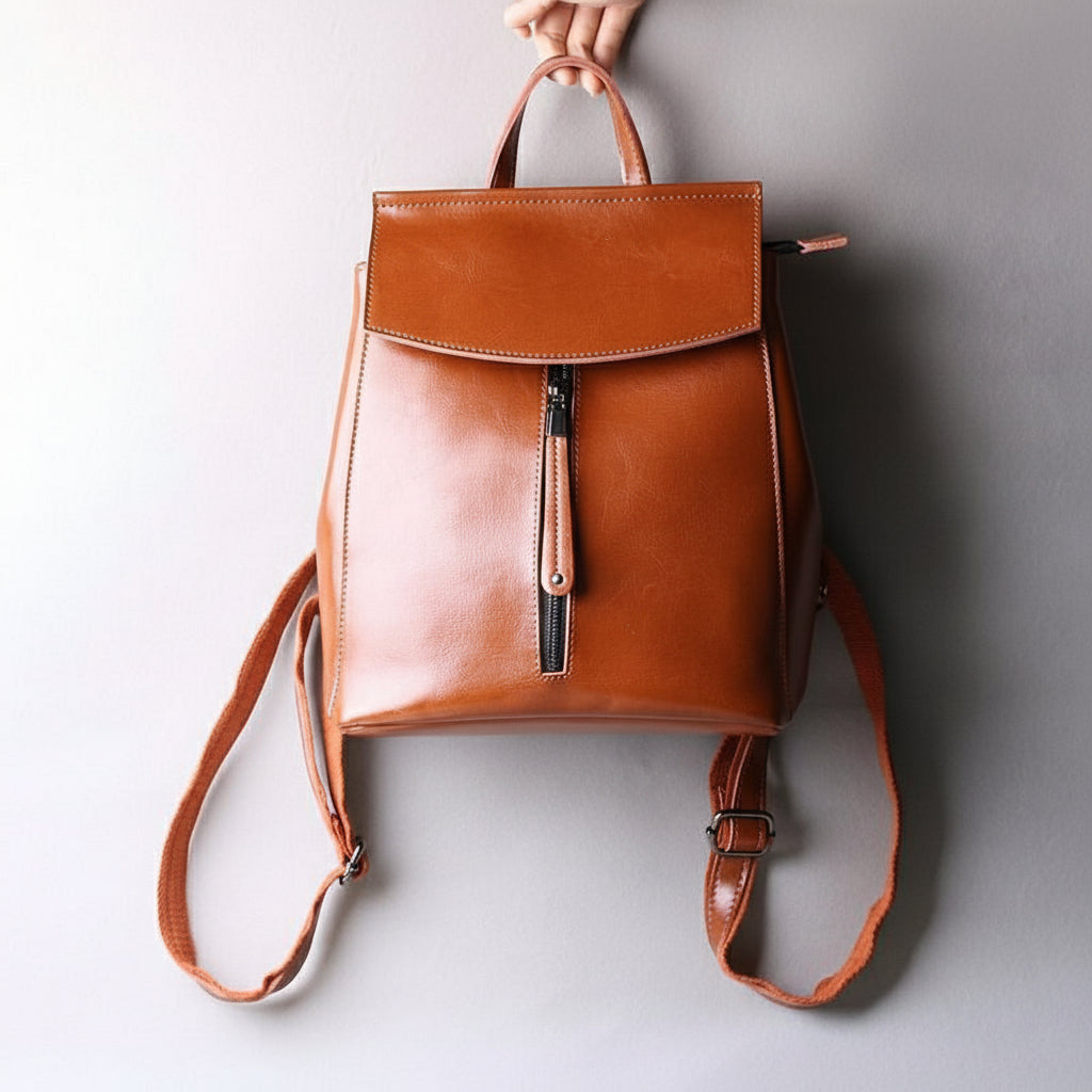 Brown leather backpack on a light gray background