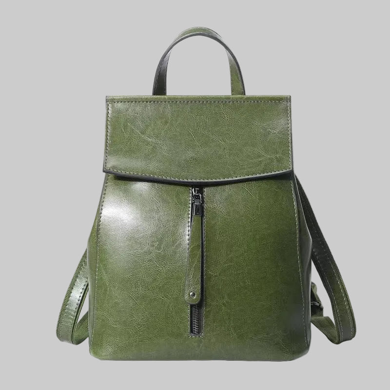 Green backpack with a zipper on a white background