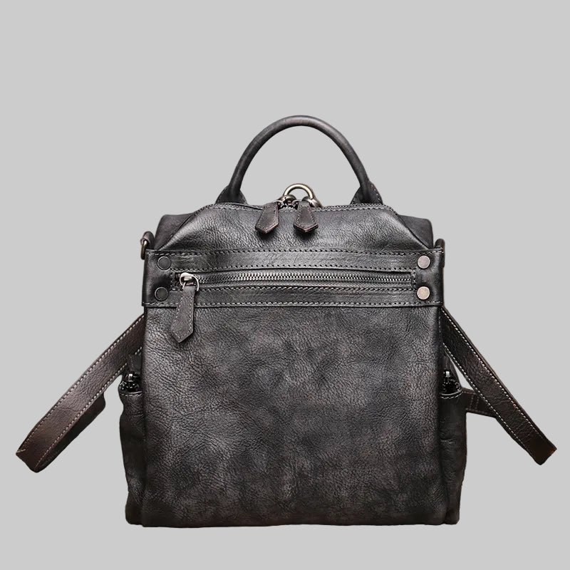 Black leather backpack on a textured brown background