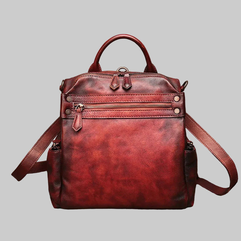 Red leather backpack on a textured brown background