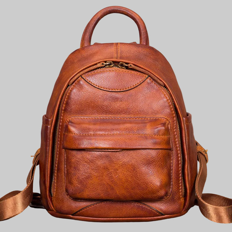 Brown leather backpack on a gray background