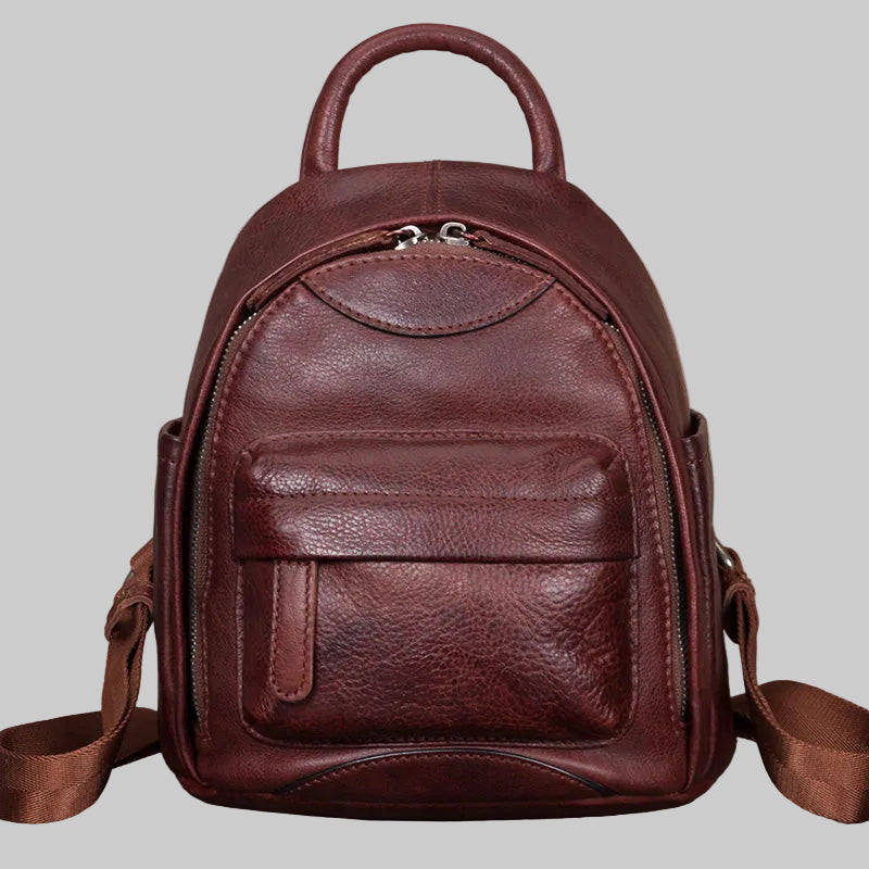 Brown leather backpack on a gray background