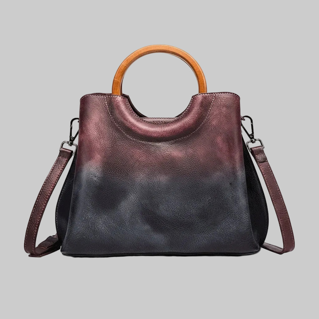 Handbag with wooden handle on a gray background