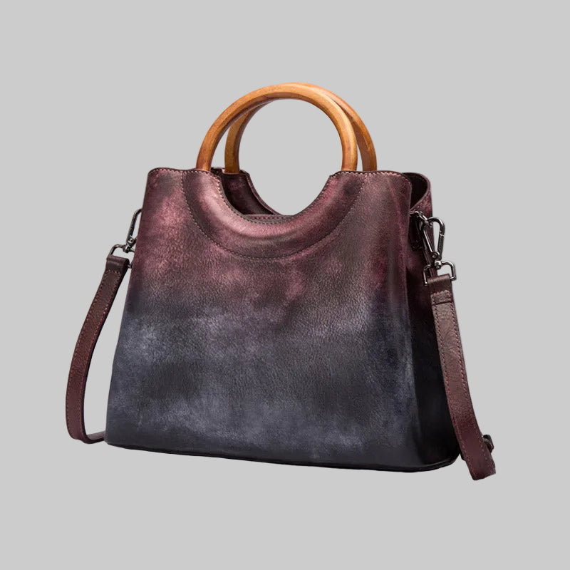 Handbag with wooden handle and gradient color on a gray background