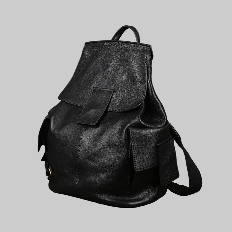 Black textured leather backpack with a top flap, front pocket, and shoulder strap, shown on a solid gray background.